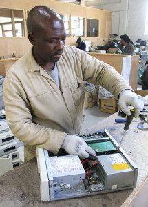 An employee of the South African pilot recycling plant dismantles a hardrive. Photo: DerekMain via Flickr for HP