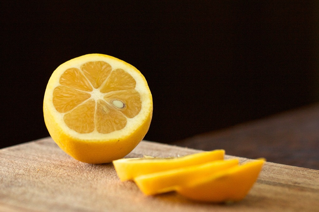 Lemon sliced on cutting board.