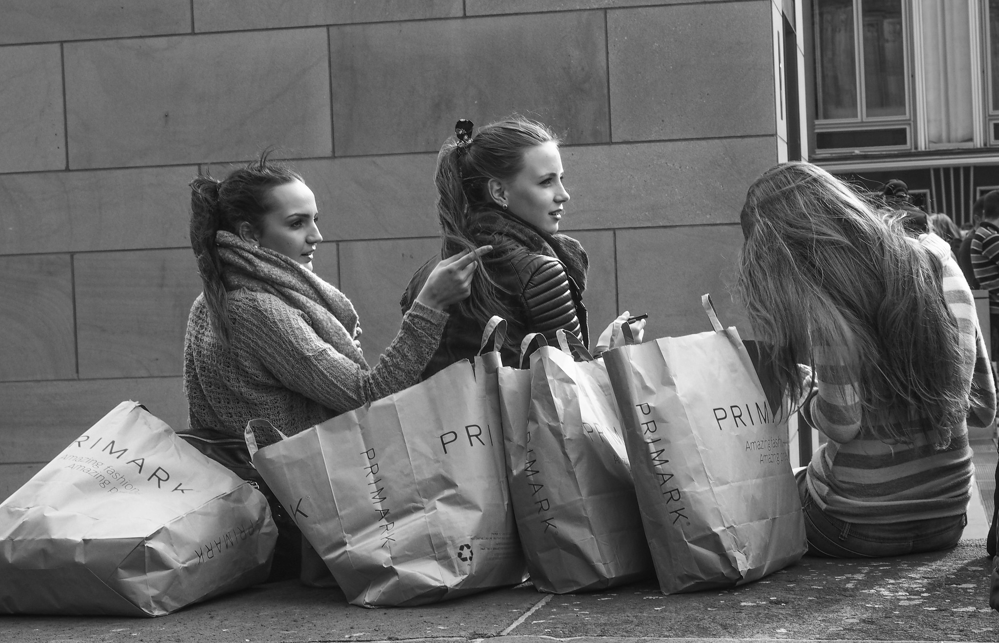Women next to shopping bags
