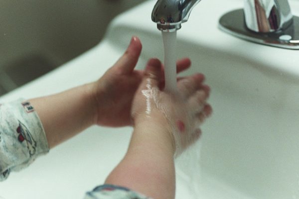 Child washing hands with soap. 