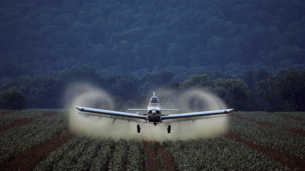 crop duster spraying agricultural crop