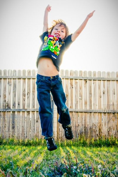 Boy jumping in backyard 