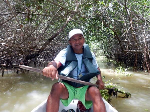Smiling guide in canoe on Isla Corazon