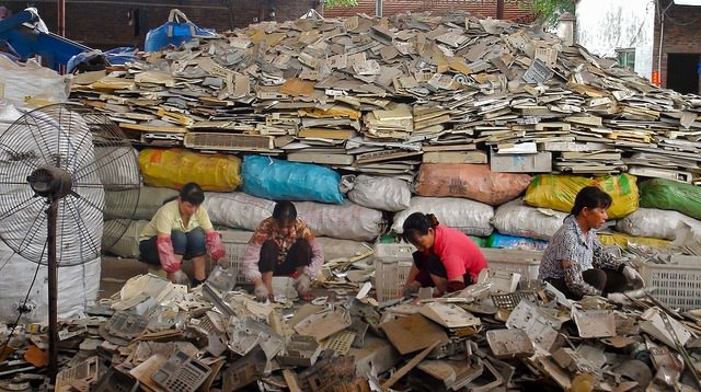 Women sorting Plastics for melting. Outskirts of Guangzhou, China. 