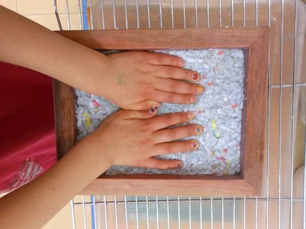 Childs hands making homemade paper