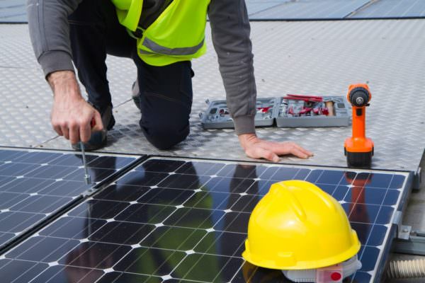 Man working on a solar renewable energy panel