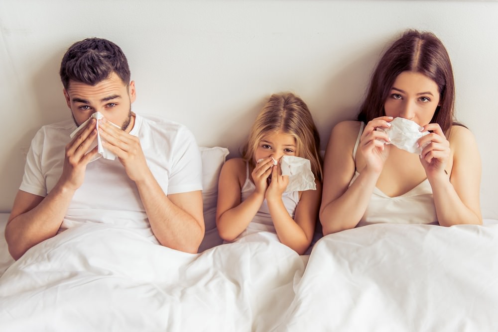 Family in bed with home allergies