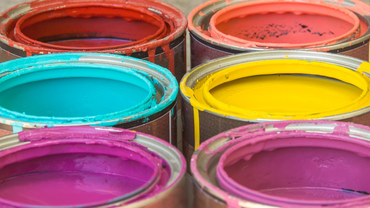close-up of colorful paints in open paint cans