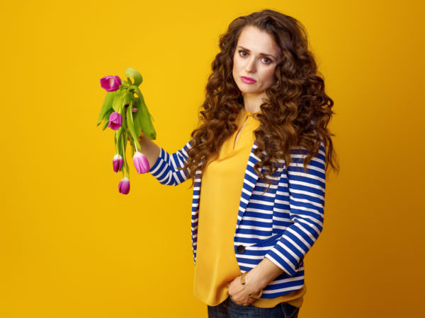 Woman holding drooping tulips