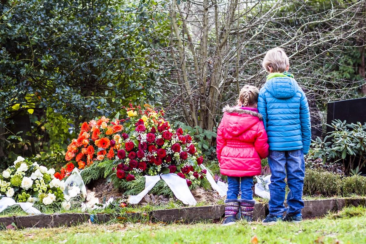 little boy and girl at graveside