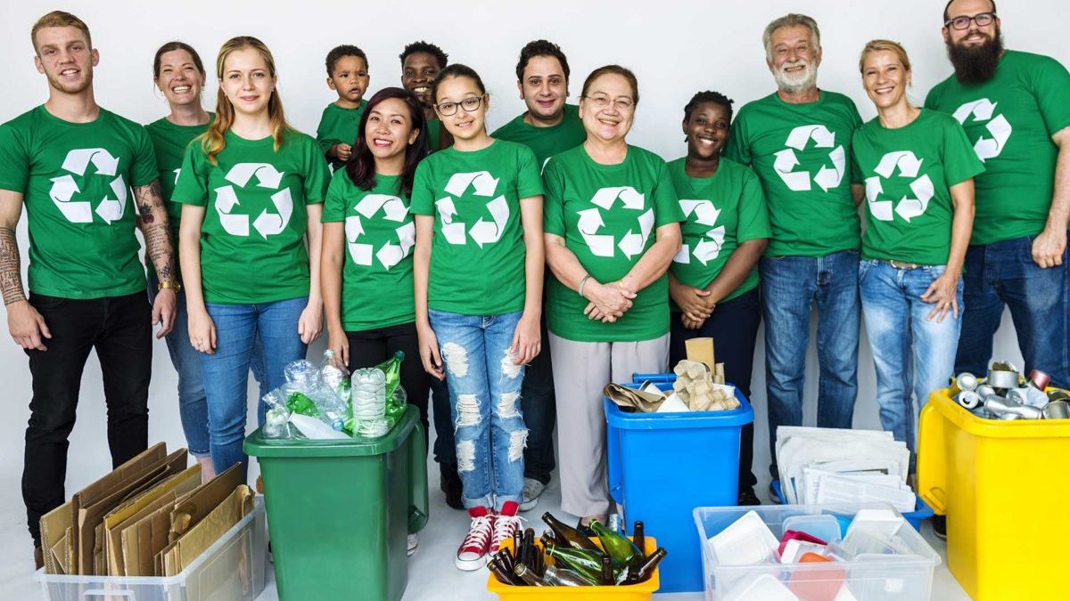 a group of adults with sorted items for recycling
