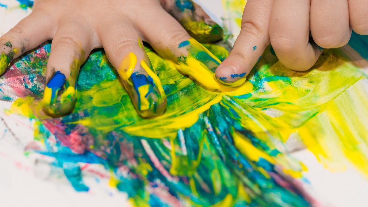 close-up of child's hands finger painting