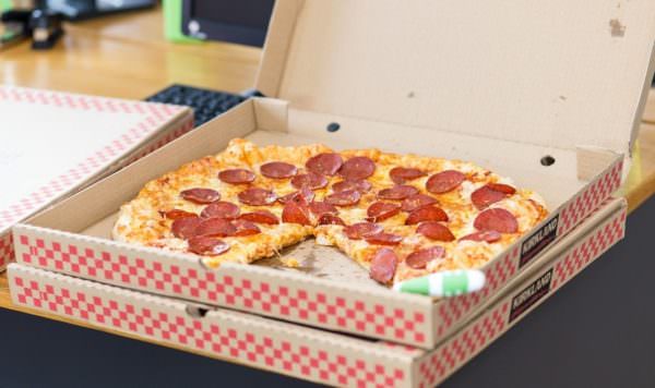 pepperoni pizza in open corrugated cardboard box