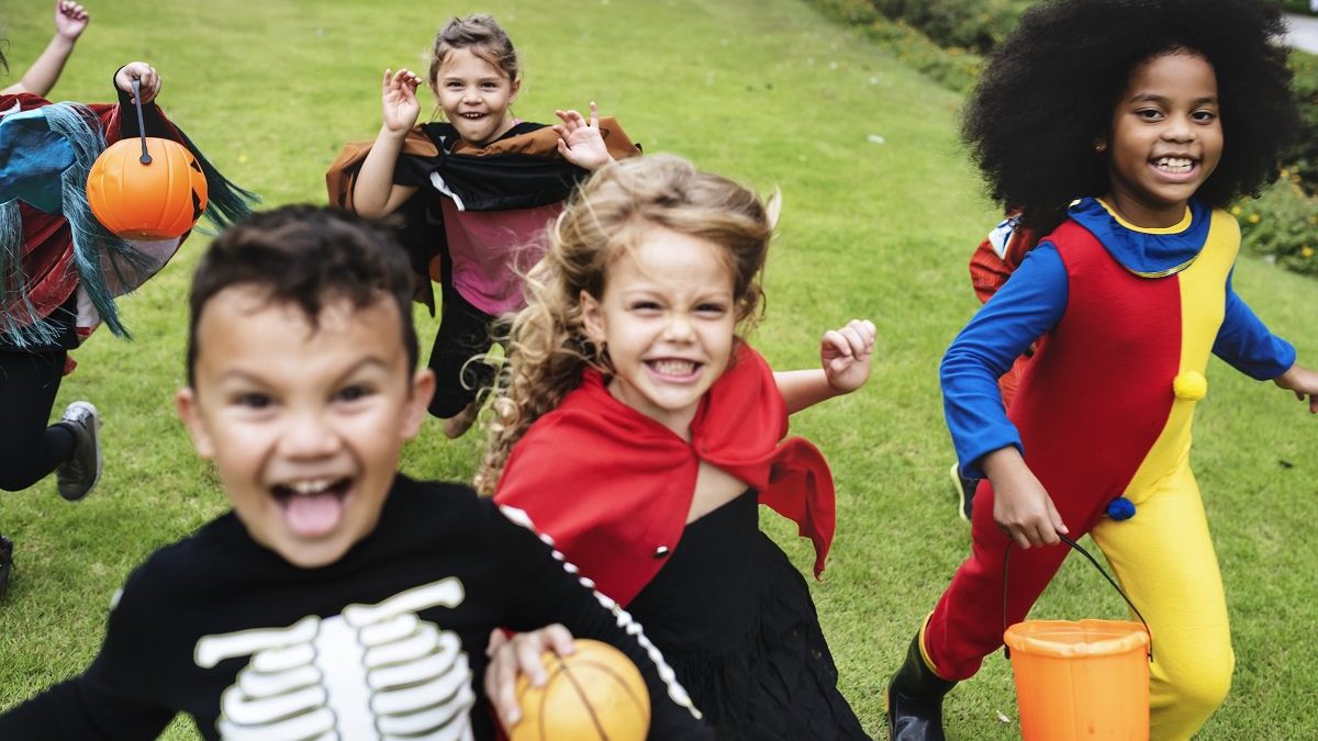 Little kids running in Halloween costumes