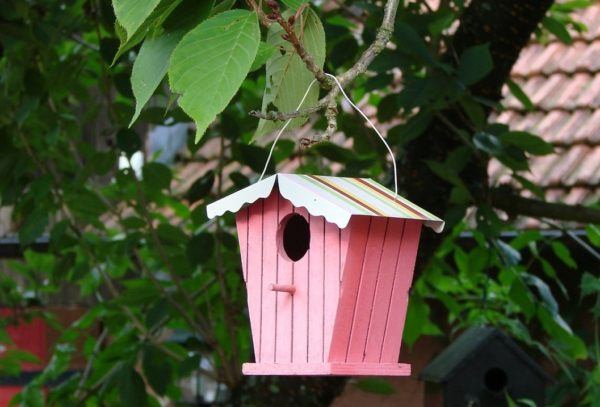 pink birdhouse with striped roof