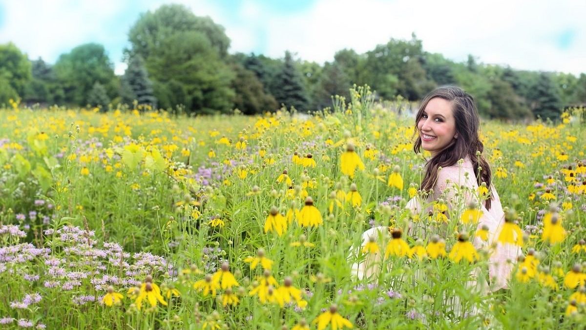 smiling woman in field of wildflowers