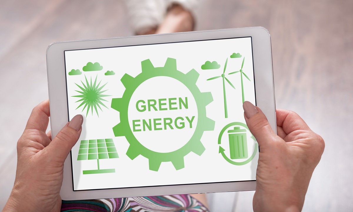 Green energy concept shown on a tablet held by a woman