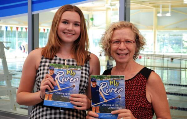 Stella Bowles and Anne Laurel Carter holding copies of "My River." 