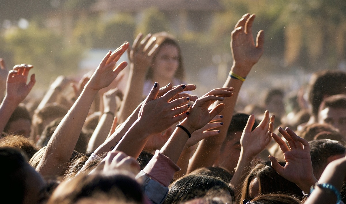 raised hands of a crowd of young people