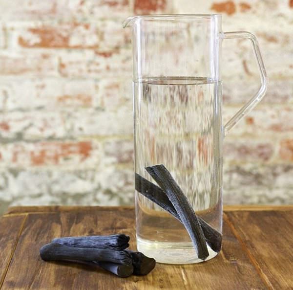binchotan charcoal in glass water pitcher