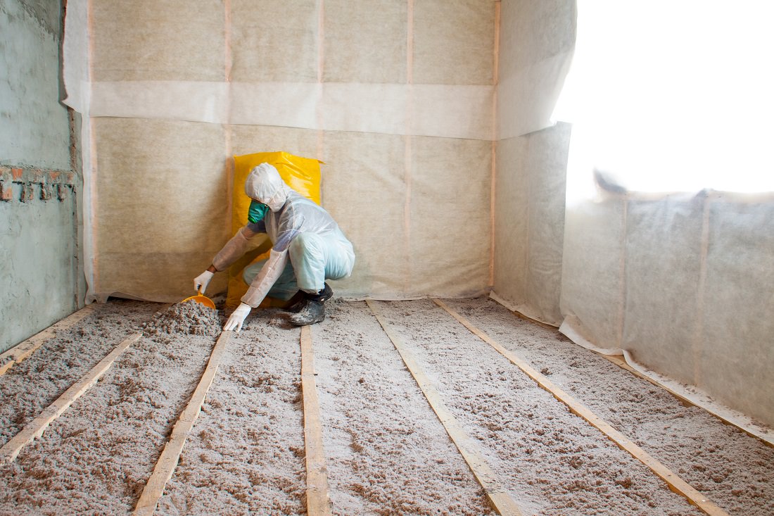 worker installing cellulose insulation