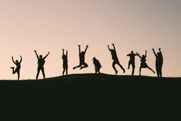 silhouettes of people jumping for joy