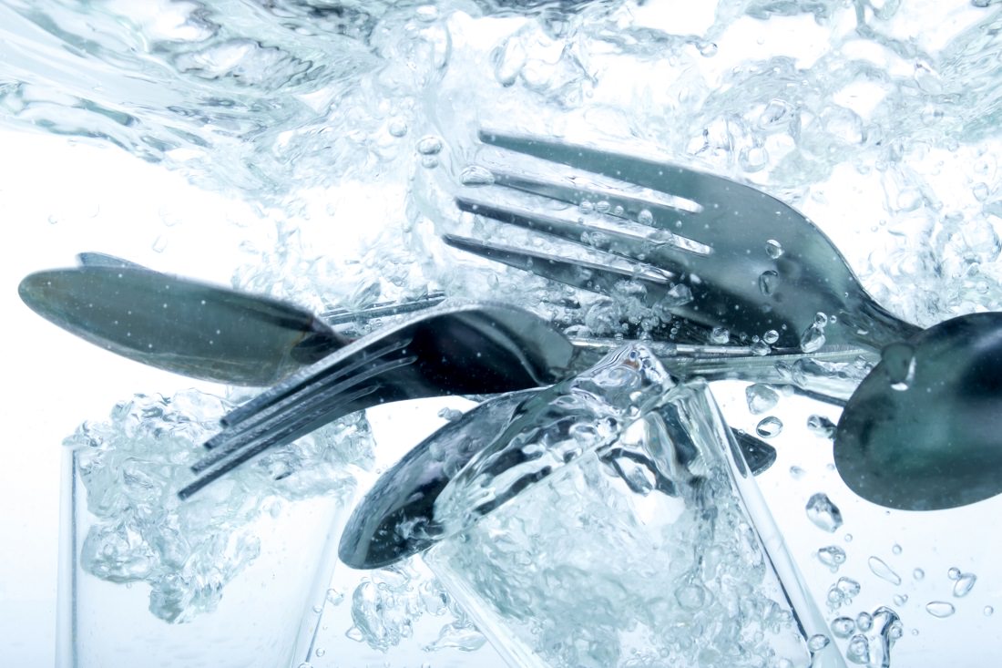 glass and flatware in turbulent water
