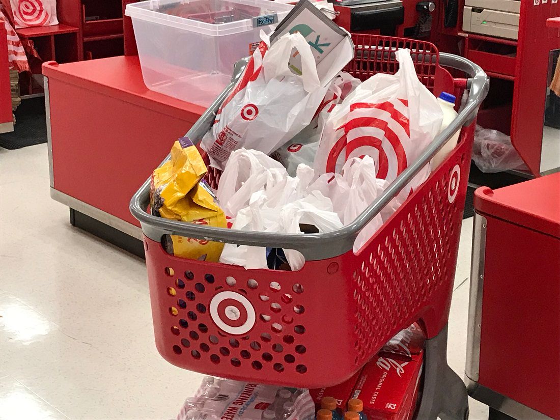 Target shopping cart filled with purchases in plastic bags