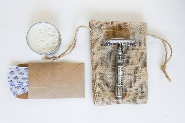 reusable metal razor, stainless steel blades, and shaving cream in a metal container