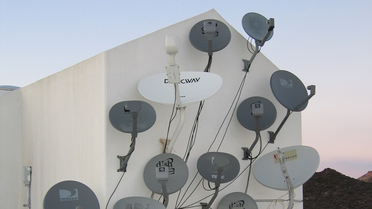 Satellite TV dishes on side of building