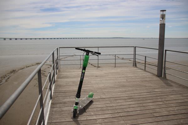 electric scooter parked on a pier at the beach