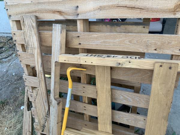 wooden pallets and metal wrecking bar