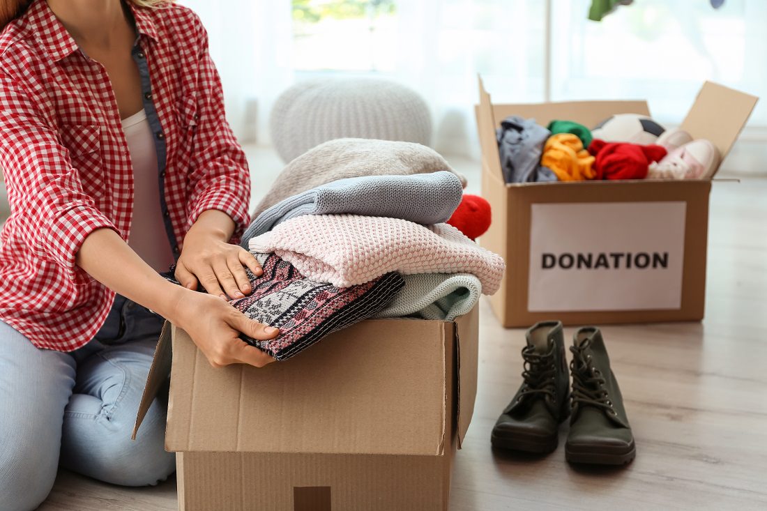 woman packing clothes to move and donate