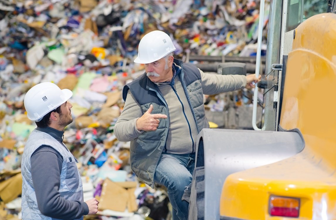 two workmen in recycling center