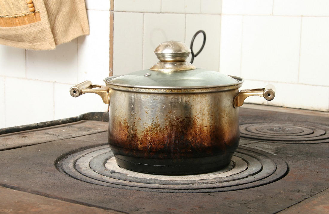 metal cook pot with lid on stove