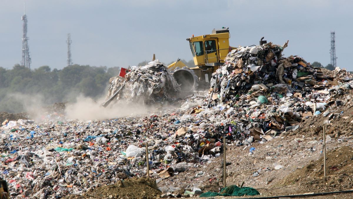 bulldozer moving sanitary landfill waste
