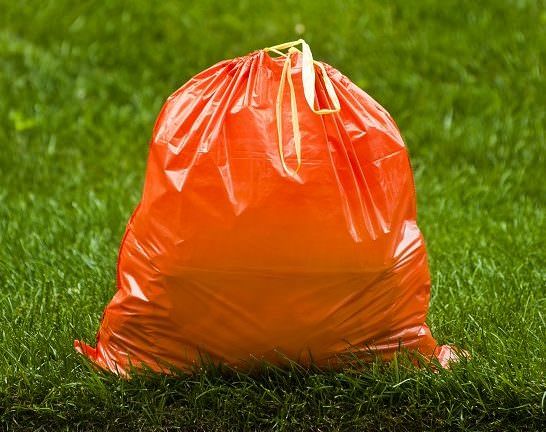 orange plastic garbage bag made with recycled materials