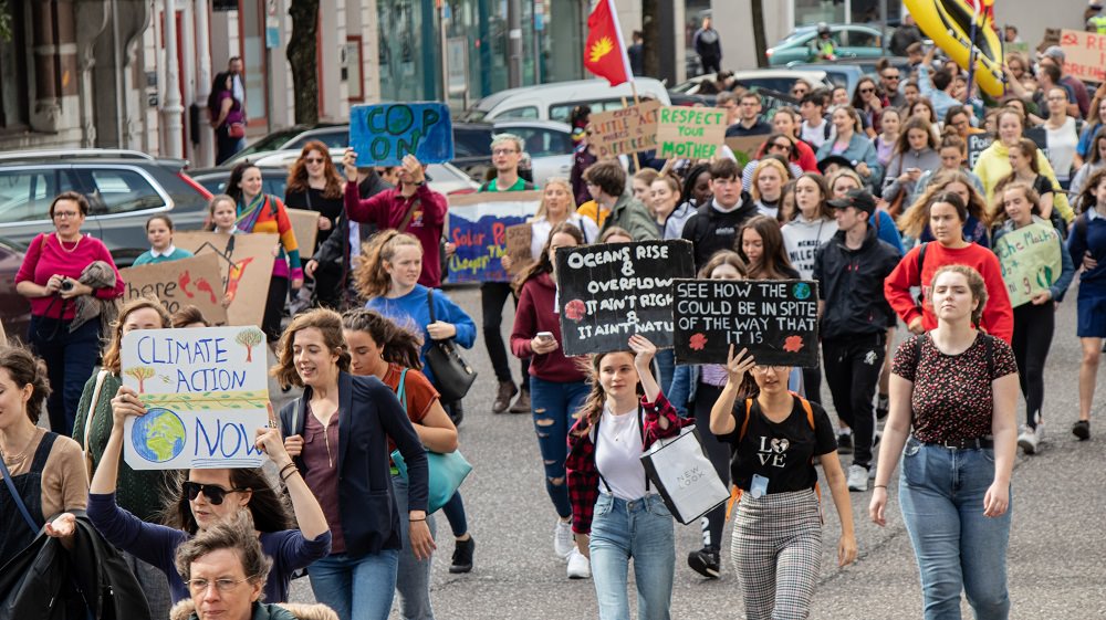 young women marching in climate change protest