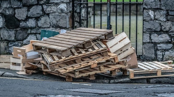 Wooden pallets discarded by side of road