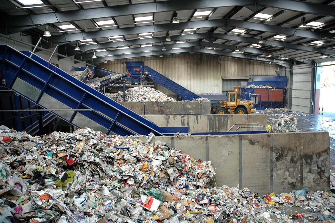 piles of solid waste at a recycling facility