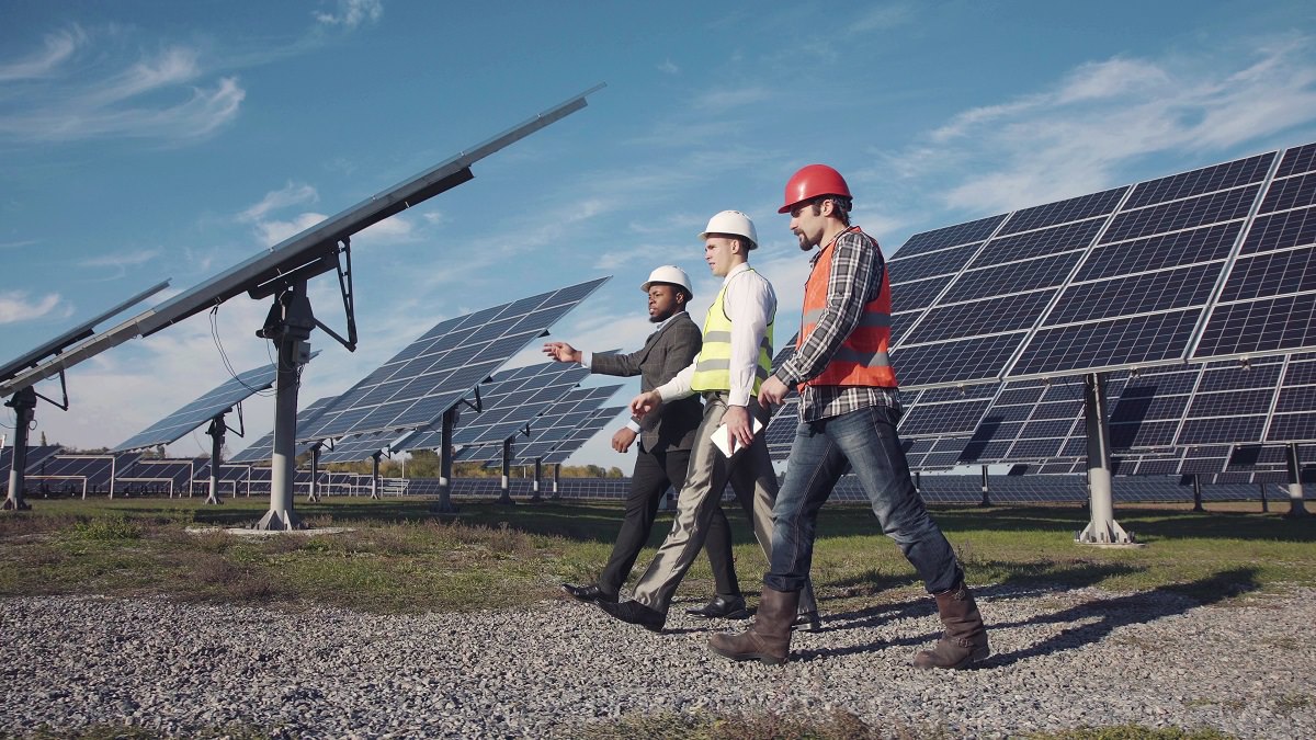 Three professionals in solar power station