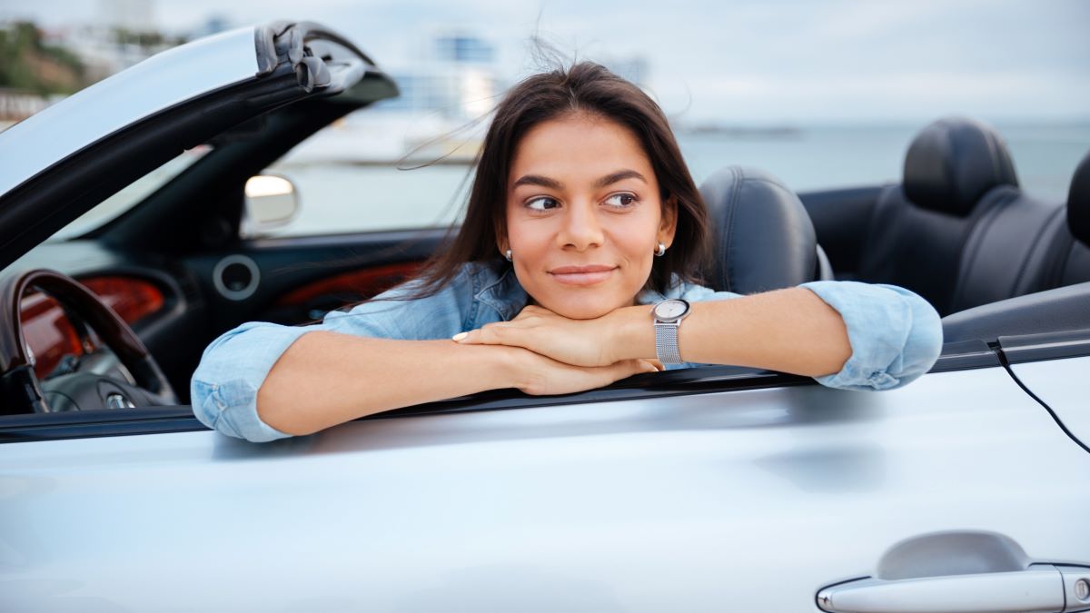 woman smiling in her car