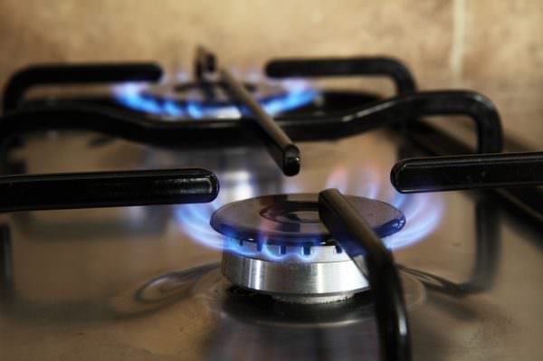 gas stove top, two burners burning