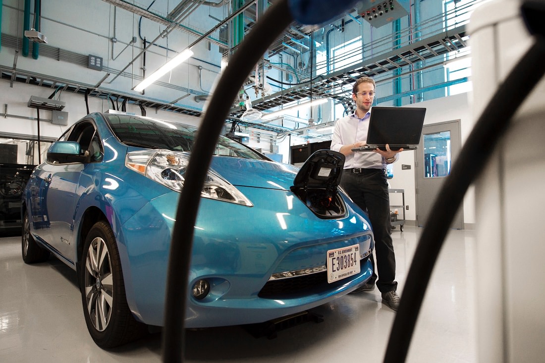technician performing electric vehicle maintenance