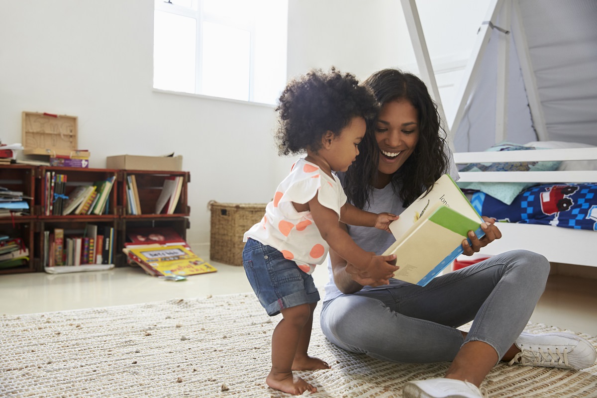 mother reading with toddler at home