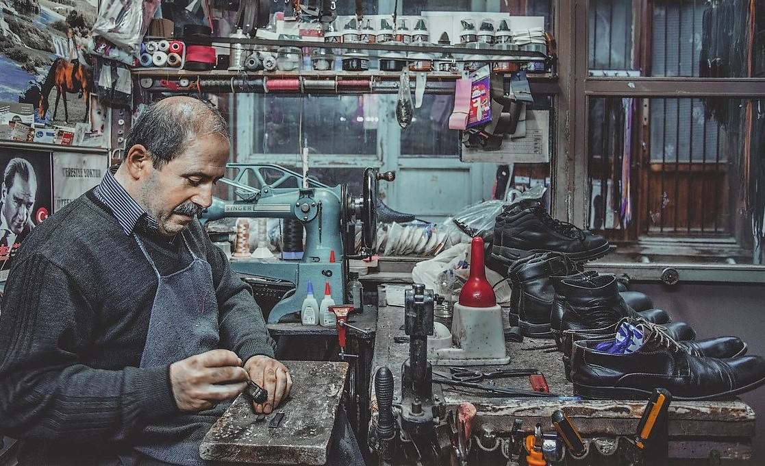 shoemaker in shoe repair shop