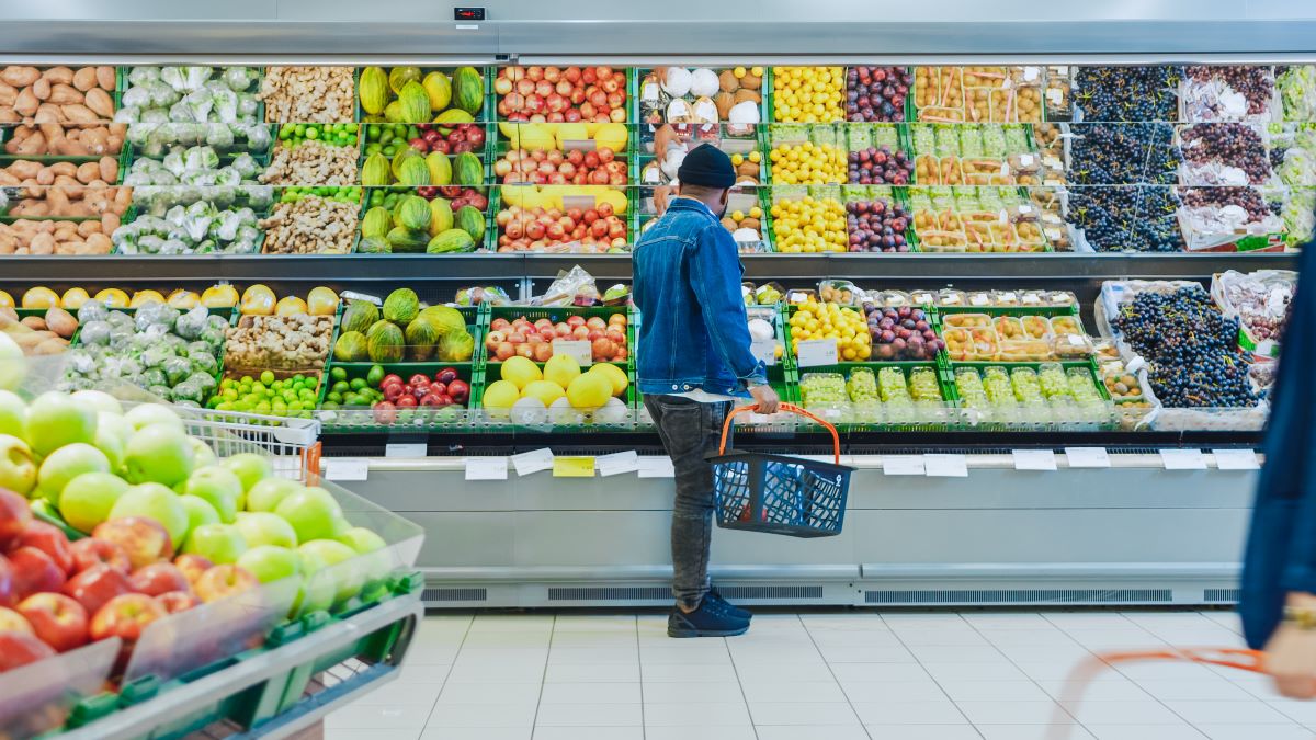 Man looking at fruit display in grocery store