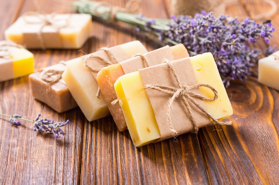 bar soap and lavender on wooden table