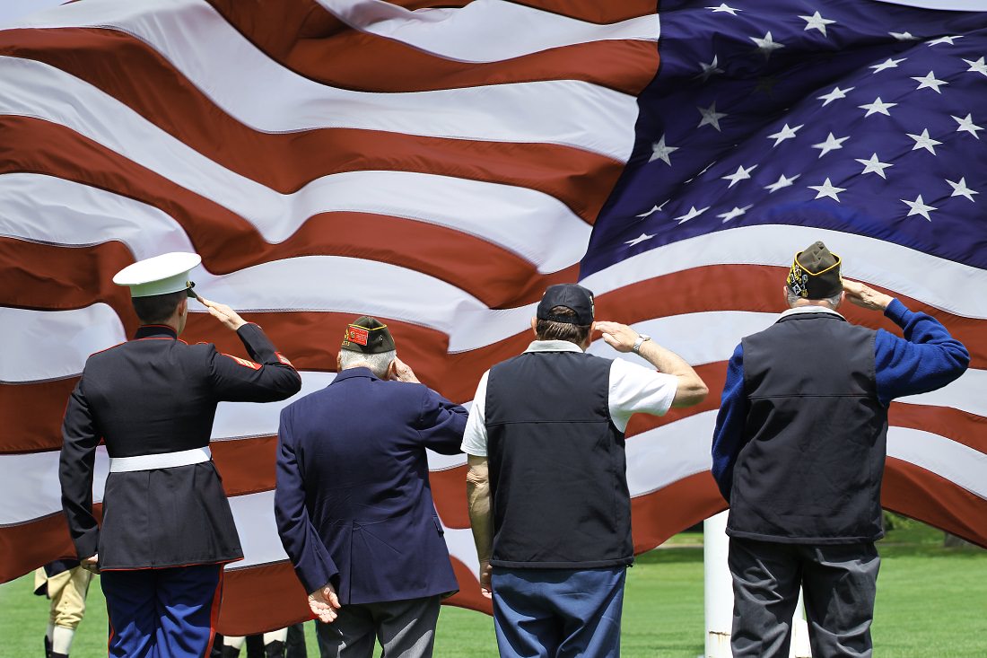 veterans saluting the U.S. flag