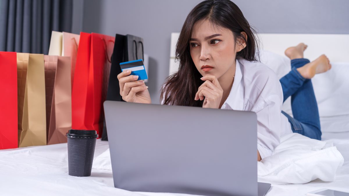 woman thinking about making an online purchase